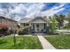 Charming home featuring a quaint front porch and well-maintained lawn under a partly cloudy sky at 3201 S Pearl St, Englewood, CO 80113
