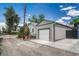 View of the detached one car garage with gray siding and concrete driveway at 3201 S Pearl St, Englewood, CO 80113