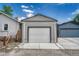 Detached one car garage with gray siding and a concrete driveway at 3201 S Pearl St, Englewood, CO 80113