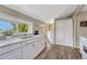 Well-lit kitchen featuring white cabinetry and a view to the exterior at 3201 S Pearl St, Englewood, CO 80113