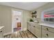 Kitchenette area with modern countertops, shelving, and access to another room at 3201 S Pearl St, Englewood, CO 80113