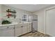 Kitchenette featuring modern countertops, stainless steel appliances, and custom shelving at 3201 S Pearl St, Englewood, CO 80113