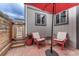 Inviting patio area with red brick, red umbrella, and striped chairs at 3201 S Pearl St, Englewood, CO 80113