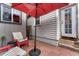 Cozy patio area with brick flooring, a red umbrella, and outdoor seating at 3201 S Pearl St, Englewood, CO 80113