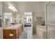 Bathroom featuring double sinks, soaking tub, and walk-in shower at 12348 W Gould Ave, Littleton, CO 80127