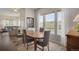 Dining room featuring natural light from large windows and access to the living room at 12348 W Gould Ave, Littleton, CO 80127