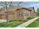 Charming one story home featuring a two car garage, lush green lawn, and mature landscaping at 12348 W Gould Ave, Littleton, CO 80127