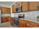 Well-equipped kitchen with stainless steel appliances, granite countertops, and ample storage at 12348 W Gould Ave, Littleton, CO 80127