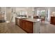 Spacious kitchen with island, stainless appliances, and views of the dining and living areas at 12348 W Gould Ave, Littleton, CO 80127