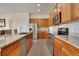 Beautifully designed kitchen featuring stainless steel appliances, granite countertops, and custom cabinetry at 12348 W Gould Ave, Littleton, CO 80127
