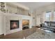 Cozy living room with stone fireplace, mounted TV, and grey sectional sofa at 12348 W Gould Ave, Littleton, CO 80127