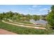 Scenic pond surrounded by lush greenery and residential homes at 12348 W Gould Ave, Littleton, CO 80127