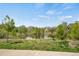 Picturesque view of neighborhood pond, trees, and distant mountains at 12348 W Gould Ave, Littleton, CO 80127