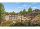 Community pool area featuring a fenced pool, hot tub, patio, mature trees, and a pergola at 12348 W Gould Ave, Littleton, CO 80127