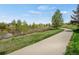 Well-maintained walking path alongside a pond and green space at 12348 W Gould Ave, Littleton, CO 80127