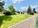 Well-maintained backyard with lush green grass and mature trees at 4192 S Vrain St, Denver, CO 80236