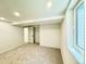 Bright basement featuring neutral carpet, white trim and a window at 4192 S Vrain St, Denver, CO 80236