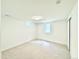 Basement with neutral carpet, trim, and a large window at 4192 S Vrain St, Denver, CO 80236