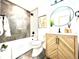 Stylish bathroom featuring a modern vanity, oval mirror, and tile accents, complete with tub at 4192 S Vrain St, Denver, CO 80236
