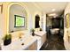 Sleek bathroom featuring dual vanities, backlit mirrors, and a luxurious glass-enclosed shower at 4192 S Vrain St, Denver, CO 80236