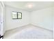 Bright bedroom featuring neutral carpet, a black trimmed window, and light fixture at 4192 S Vrain St, Denver, CO 80236