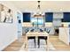 Dining room featuring stylish light fixture, table setting, and a view of the modern kitchen at 4192 S Vrain St, Denver, CO 80236
