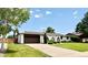 Charming ranch-style home with a well-manicured lawn, a long driveway, and a two car garage in a suburban setting at 4192 S Vrain St, Denver, CO 80236