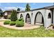 Close up shot of exterior with brick arches, rock garden, and nicely trimmed bushes at 4192 S Vrain St, Denver, CO 80236
