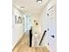 A bright hallway with laminate flooring, neutral walls, and staircase to basement at 4192 S Vrain St, Denver, CO 80236