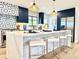 Eat-in kitchen featuring a large island with bar seating and stylish pendant lights at 4192 S Vrain St, Denver, CO 80236