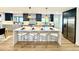 Modern kitchen with a large island, bar stool seating, and pendant lighting at 4192 S Vrain St, Denver, CO 80236
