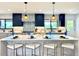 Charming kitchen with a decorative backsplash, updated appliances, and breakfast bar seating at 4192 S Vrain St, Denver, CO 80236