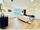 Spacious living room with a stylish entertainment center, hardwood floors, and modern furnishings at 4192 S Vrain St, Denver, CO 80236