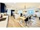 Open-concept living space with a modern kitchen, dining area, and seating, all bathed in natural light at 4192 S Vrain St, Denver, CO 80236