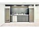 Basement wet bar including beverage coolers, sink, neutral counter tops, and dark grey cabinets at 4192 S Vrain St, Denver, CO 80236