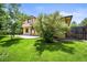 Exterior view of a two-story home with mature trees and a backyard patio at 11072 Zephyr St, Broomfield, CO 80021