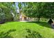 Expansive backyard featuring lush green grass, mature trees, and a patio with outdoor seating at 11072 Zephyr St, Broomfield, CO 80021