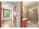Bathroom featuring a shower, oak vanity, and tiled walls at 11072 Zephyr St, Broomfield, CO 80021