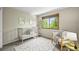 Cozy Bedroom featuring a white crib, comfortable chair, area rug and natural light at 11072 Zephyr St, Broomfield, CO 80021