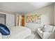 Comfortable bedroom with modern decor, a comfortable bed, and a seating area at 11072 Zephyr St, Broomfield, CO 80021