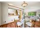 Open dining room with hardwood floors and modern decor, connecting to the kitchen and living areas at 11072 Zephyr St, Broomfield, CO 80021