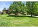 Well-maintained front yard with lush green grass, mature trees, and colorful landscaping at 11072 Zephyr St, Broomfield, CO 80021