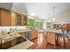 Bright kitchen with stainless steel appliances, wood cabinets, and views to the dining and living areas at 11072 Zephyr St, Broomfield, CO 80021