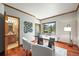 Bright office space with hardwood floors, wood trim, a modern desk, and bathroom access at 11072 Zephyr St, Broomfield, CO 80021