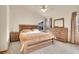 Spacious primary bedroom boasts a ceiling fan, dresser, carpet, and lots of natural light at 1214 S Akron Way, Denver, CO 80247