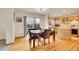Bright dining area with hardwood floors, a sliding glass door, and open access to the kitchen at 1214 S Akron Way, Denver, CO 80247