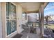 Inviting front porch with seating area, providing a cozy outdoor space to relax and enjoy the neighborhood views at 1214 S Akron Way, Denver, CO 80247