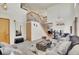 Inviting living room featuring a cozy seating arrangement, staircase, a large mirror and tall ceilings at 1214 S Akron Way, Denver, CO 80247