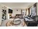 Cozy living room with a fireplace, mounted TV, and comfortable leather seating, perfect for relaxation at 1214 S Akron Way, Denver, CO 80247