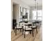 Bright dining area next to kitchen featuring sleek chairs, white countertops, and modern pendant lighting at 8280 E 36Th Ave # 27, Denver, CO 80238